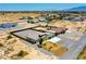 Spacious fenced desert home with a two-car garage and extended metal awning in a rural desert community at 1801 S Manzanita Dr, Pahrump, NV 89048