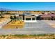 Expansive lot featuring a modern single-story home with a spacious driveway and fenced yard at 1801 S Manzanita Dr, Pahrump, NV 89048