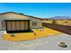 The backyard is xeriscaped with gravel, a fire pit and chainlink fencing to enjoy the mountain view at 1801 S Manzanita Dr, Pahrump, NV 89048