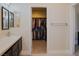 Bathroom featuring a large vanity with sink, mirror, and a door leading to a closet at 1801 S Manzanita Dr, Pahrump, NV 89048