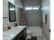 Bathroom showcases a single sink vanity, a shower-tub combo, and modern gray tile at 1801 S Manzanita Dr, Pahrump, NV 89048