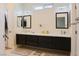 Bright bathroom featuring dual sinks, floating cabinetry, and stylish lighting at 1801 S Manzanita Dr, Pahrump, NV 89048