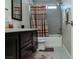 Bathroom showcases a single sink vanity, a shower-tub combo, and modern gray tile at 1801 S Manzanita Dr, Pahrump, NV 89048