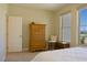 Bright bedroom with a dresser, window, white walls, and comfortable bed at 1801 S Manzanita Dr, Pahrump, NV 89048