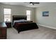 Expansive bedroom with large windows, a dark wood bed frame, and comfortable carpet for a cozy feel at 1801 S Manzanita Dr, Pahrump, NV 89048