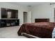 Well-lit bedroom with large TV and closet for storage needs and entertainment at 1801 S Manzanita Dr, Pahrump, NV 89048