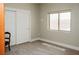 Clean, vacant bedroom features plush carpet, a closet, and a window that brings in bright natural light at 1801 S Manzanita Dr, Pahrump, NV 89048