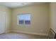 An empty bedroom featuring a large window and neutral walls at 1801 S Manzanita Dr, Pahrump, NV 89048