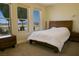 Bedroom with stylish wood bed frame, bedside tables, and large windows at 1801 S Manzanita Dr, Pahrump, NV 89048