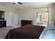 Large bedroom featuring neutral carpet, ample space and a sliding glass door at 1801 S Manzanita Dr, Pahrump, NV 89048