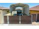 View of a white van under a metal carport with privacy screen fencing at 1801 S Manzanita Dr, Pahrump, NV 89048