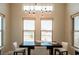Bright dining room featuring modern light fixture and windows that bring in plenty of natural light at 1801 S Manzanita Dr, Pahrump, NV 89048