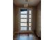 Welcoming foyer with modern frosted glass door and tiled floors with stylish modern pendant light at 1801 S Manzanita Dr, Pahrump, NV 89048