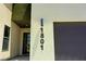 Exterior of a home displaying the house number with a dark gray garage door at 1801 S Manzanita Dr, Pahrump, NV 89048