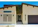Modern home featuring an attractive front entrance and a spacious three-car garage at 1801 S Manzanita Dr, Pahrump, NV 89048