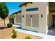 Exterior view showing stucco walls and landscaping with a covered walkway to the front door at 1801 S Manzanita Dr, Pahrump, NV 89048