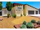 Inviting single-story home with desert landscaping, rock mulch, and a wide two-car garage at 1801 S Manzanita Dr, Pahrump, NV 89048