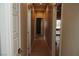 Tiled hallway with neutral walls, white doors, and recessed lighting, offering a clean and modern aesthetic at 1801 S Manzanita Dr, Pahrump, NV 89048
