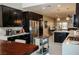 Modern kitchen with stainless steel appliances, quartz countertops, and sleek dark wood cabinets at 1801 S Manzanita Dr, Pahrump, NV 89048