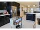 Open kitchen with stainless steel appliances, a rolling island, and modern cabinets at 1801 S Manzanita Dr, Pahrump, NV 89048