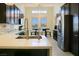 Modern kitchen with stainless steel appliances, quartz countertops, and an adjacent dining area at 1801 S Manzanita Dr, Pahrump, NV 89048