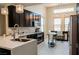 Modern kitchen with stainless steel appliances, sleek cabinets, and bar seating at 1801 S Manzanita Dr, Pahrump, NV 89048