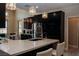 Bright kitchen area with stainless steel appliances, dark cabinetry, and quartz countertops at 1801 S Manzanita Dr, Pahrump, NV 89048