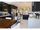 Spacious kitchen with a center island, modern appliances, dark cabinets, and an adjacent dining area at 1801 S Manzanita Dr, Pahrump, NV 89048