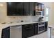 Modern kitchen features stainless steel appliances, dark cabinets, and white countertops at 1801 S Manzanita Dr, Pahrump, NV 89048