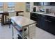 Modern kitchen boasts stainless steel prep table, dark cabinets, and white countertops at 1801 S Manzanita Dr, Pahrump, NV 89048