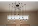 Unique and modern exposed-bulb chandelier adding a touch of elegance to the home's decor at 1801 S Manzanita Dr, Pahrump, NV 89048