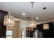 Striking crystal pendant lights illuminating the kitchen with recessed lighting and lots of storage at 1801 S Manzanita Dr, Pahrump, NV 89048