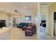 Bright living room featuring tile floors, a ceiling fan, and views into another room at 1801 S Manzanita Dr, Pahrump, NV 89048
