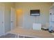 A home office with a desk, chair, shelves, and wall-mounted television at 1801 S Manzanita Dr, Pahrump, NV 89048