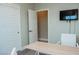 A well-lit office featuring white doors, a mounted flat-screen TV, and a desk for a productive workspace at 1801 S Manzanita Dr, Pahrump, NV 89048