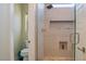 Modern bathroom shower featuring stylish tile, a small window, and a built in toiletry niche at 1801 S Manzanita Dr, Pahrump, NV 89048