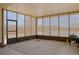 Bright sunroom featuring screened windows, concrete flooring and backyard access for relaxing and entertaining at 1801 S Manzanita Dr, Pahrump, NV 89048