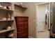 Walk-in closet with shelves, drawers, and access to bathroom with white door at 1801 S Manzanita Dr, Pahrump, NV 89048