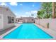 Large, sparkling pool surrounded by a concrete deck and detached structure at 1905 E Oakey Blvd, Las Vegas, NV 89104