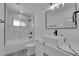 Modern bathroom featuring white marble-look tile and black hardware at 1905 E Oakey Blvd, Las Vegas, NV 89104