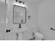 Well-lit bathroom featuring a pedestal sink and white fixtures at 1905 E Oakey Blvd, Las Vegas, NV 89104