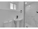 Modern bathroom featuring a white pedestal sink, shower with marble surround, and tiled floors at 1905 E Oakey Blvd, Las Vegas, NV 89104