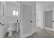 Updated bathroom with a white pedestal sink, tiled floors and a frosted glass door at 1905 E Oakey Blvd, Las Vegas, NV 89104