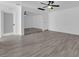 An empty bedroom offers wood-look floors, ceiling fan, closet with mirrored doors and white trim at 1905 E Oakey Blvd, Las Vegas, NV 89104