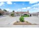Charming single-story home featuring a spacious front yard with mature landscaping and a large driveway at 1905 E Oakey Blvd, Las Vegas, NV 89104