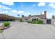 Charming single-story home featuring a spacious front yard with mature landscaping and a large driveway at 1905 E Oakey Blvd, Las Vegas, NV 89104