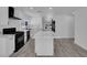 Open kitchen featuring an island with white countertops, modern appliances and white cabinetry at 1905 E Oakey Blvd, Las Vegas, NV 89104