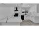 Modern kitchen with white cabinetry, island, quartz countertops, and black stainless steel appliances at 1905 E Oakey Blvd, Las Vegas, NV 89104