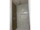 Bathroom shower with a shower head and marble tiling at 1905 Harvard St, North Las Vegas, NV 89030
