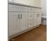 Bathroom vanity with white cabinets, silver hardware, and wood floors at 1905 Harvard St, North Las Vegas, NV 89030